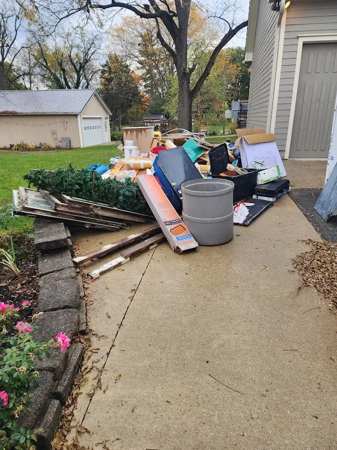 Dumpster being loaded with debris for Commercial Dumpster Rental in Cozad
